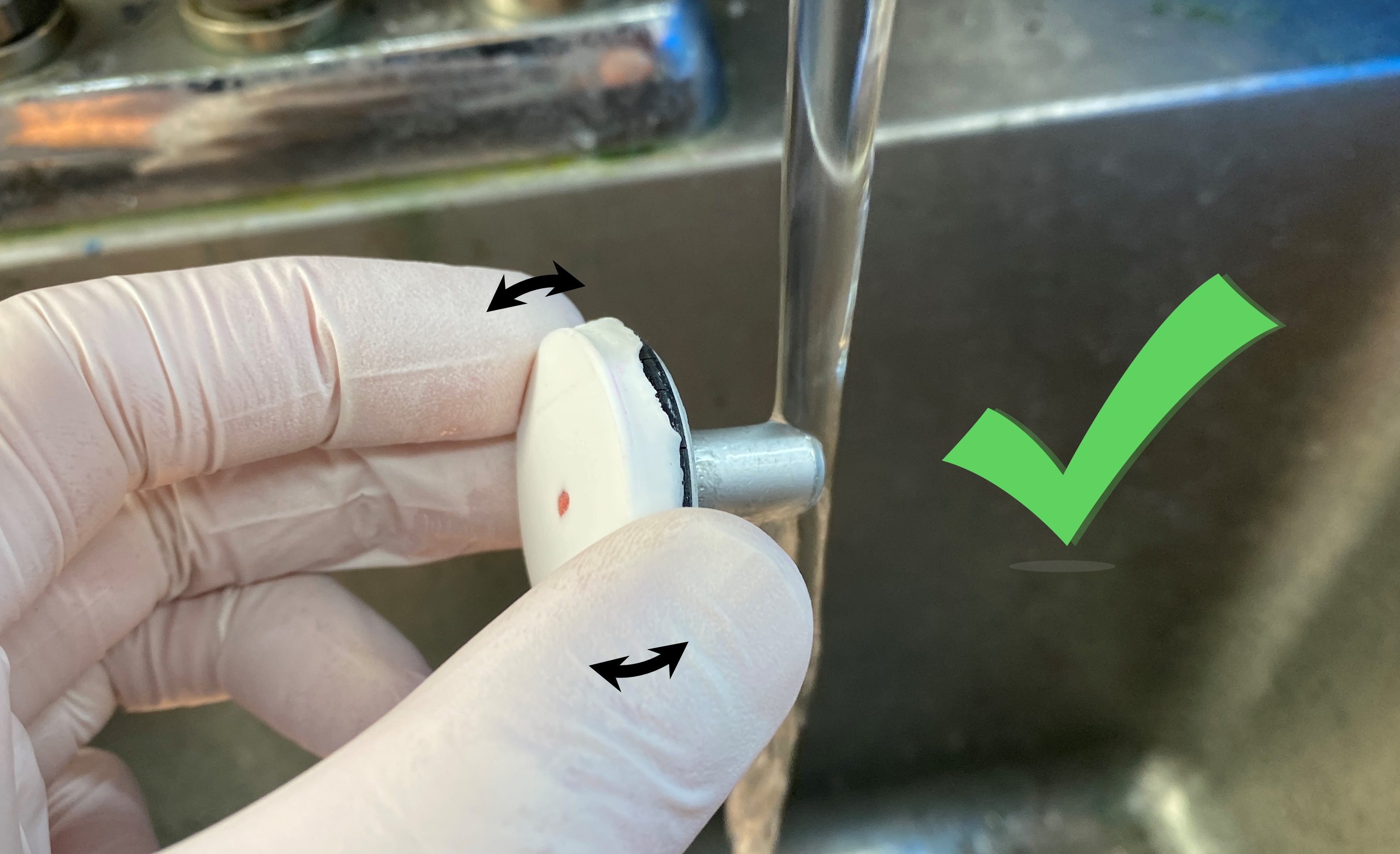 Rather, apply hot water to the stem of the chuck, while slightly tilting your grip of the top to apply pressure towards making the block slide off the chuck. As soon as you feel it starting to move, move away from the sink and finish sliding the block off the chuck.