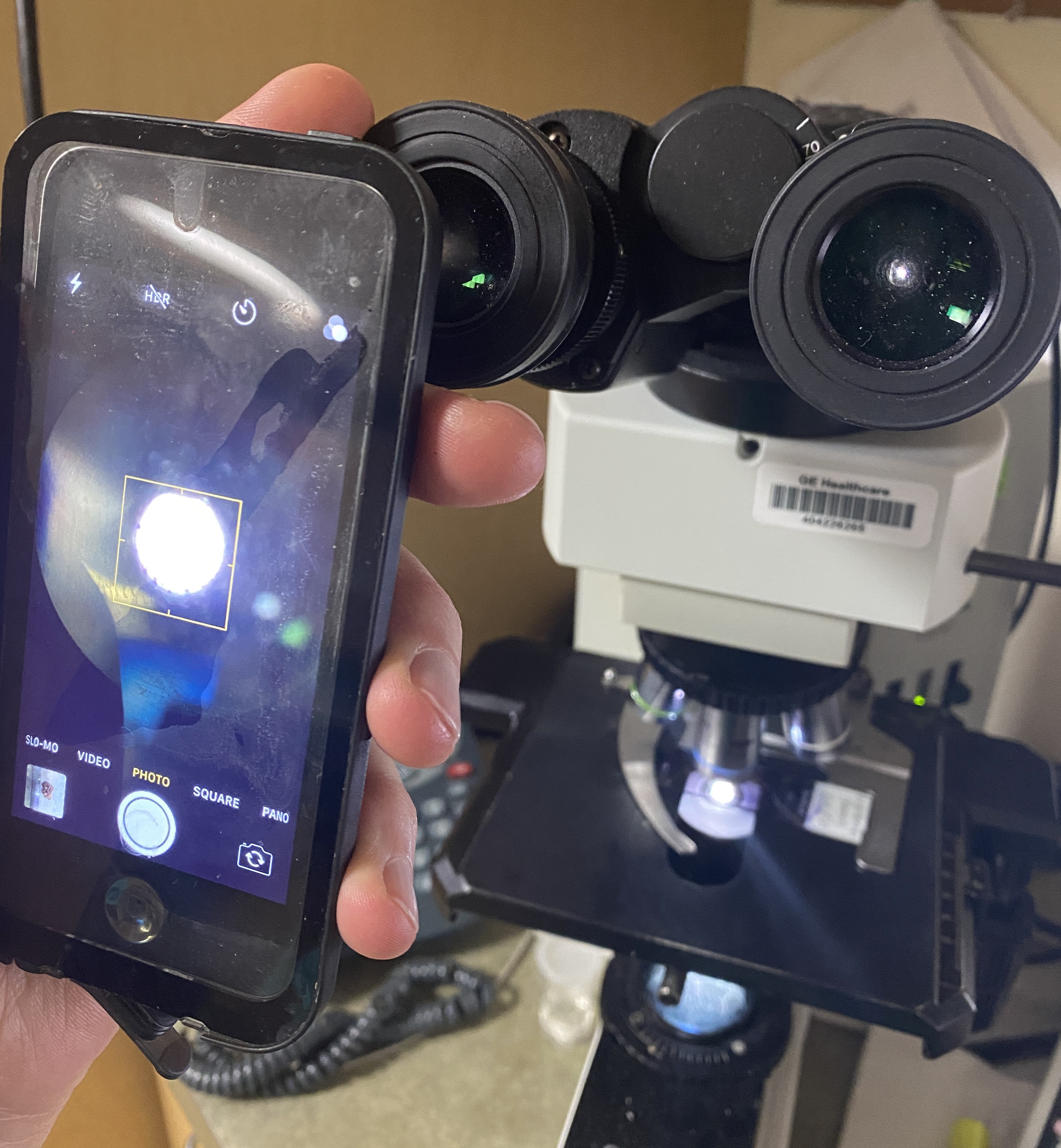To perform micrography with a smartphone, stabilize the smartphone over the eyepiece (preferably using both hands), about 3-5 cm away from it, and direct it on the bright circle on your phone display...